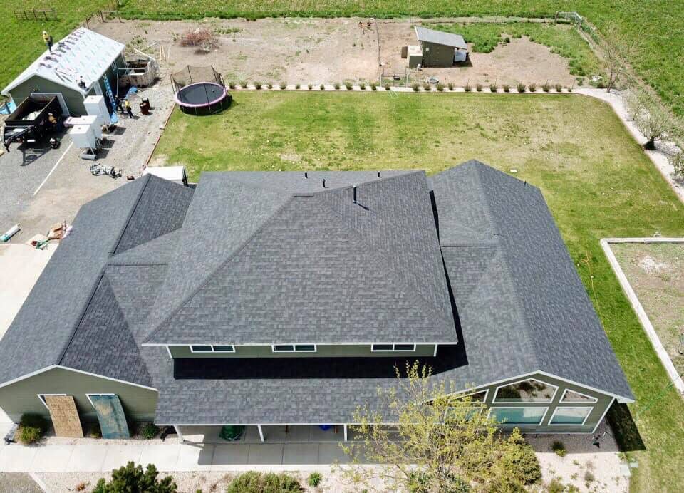 Green house with roofing work completed.